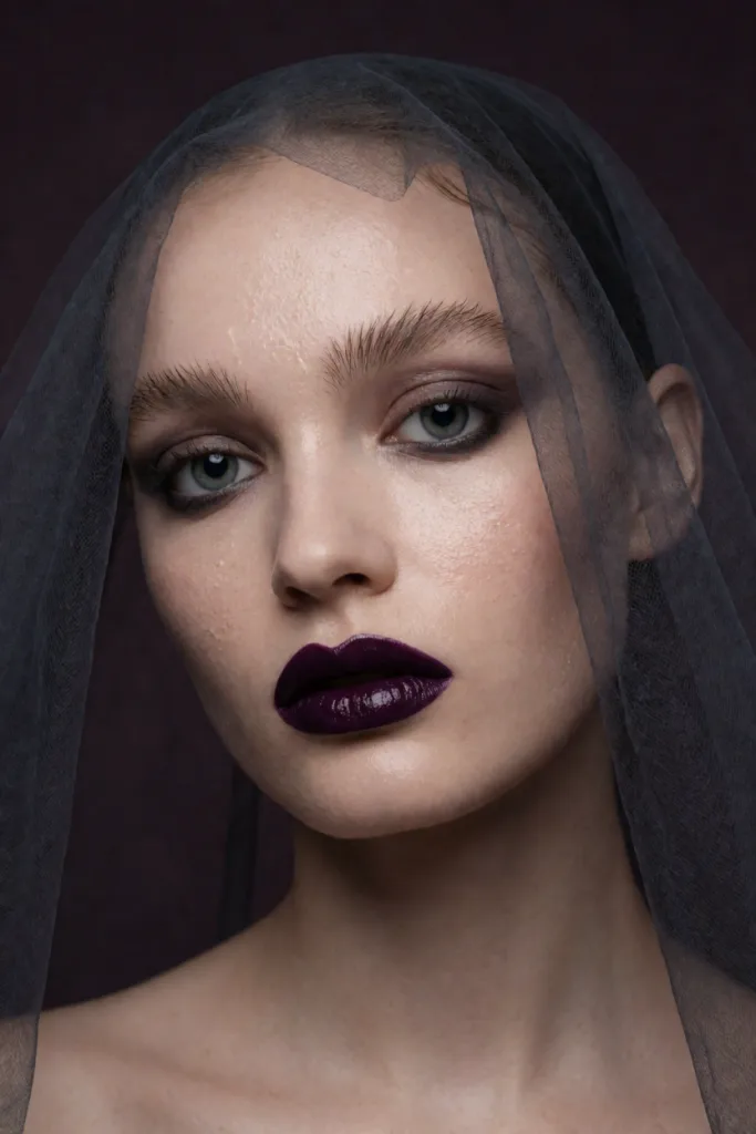 Aubergine lacquer lips under a smoke veil