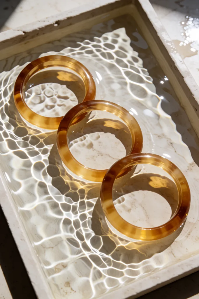 Amber resin bangles in sunlit water