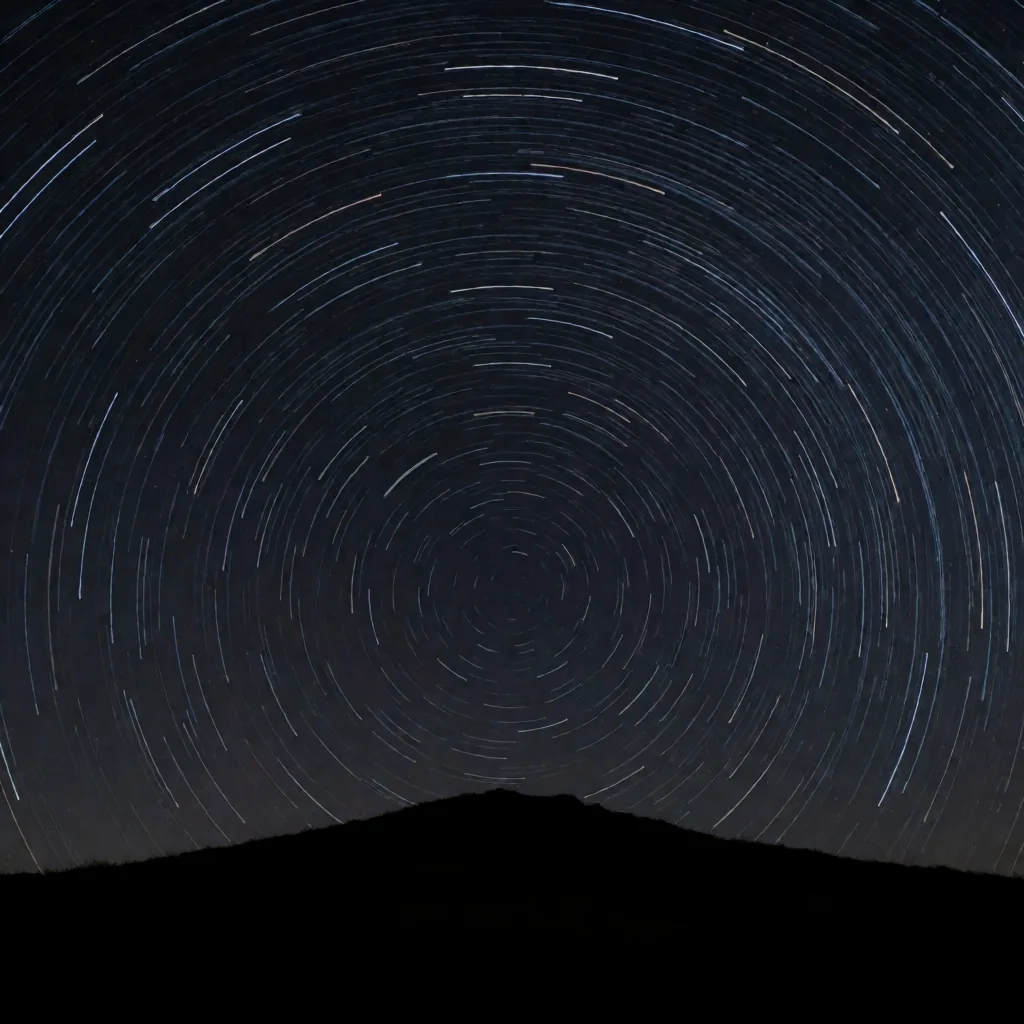 Star trails over a ridge